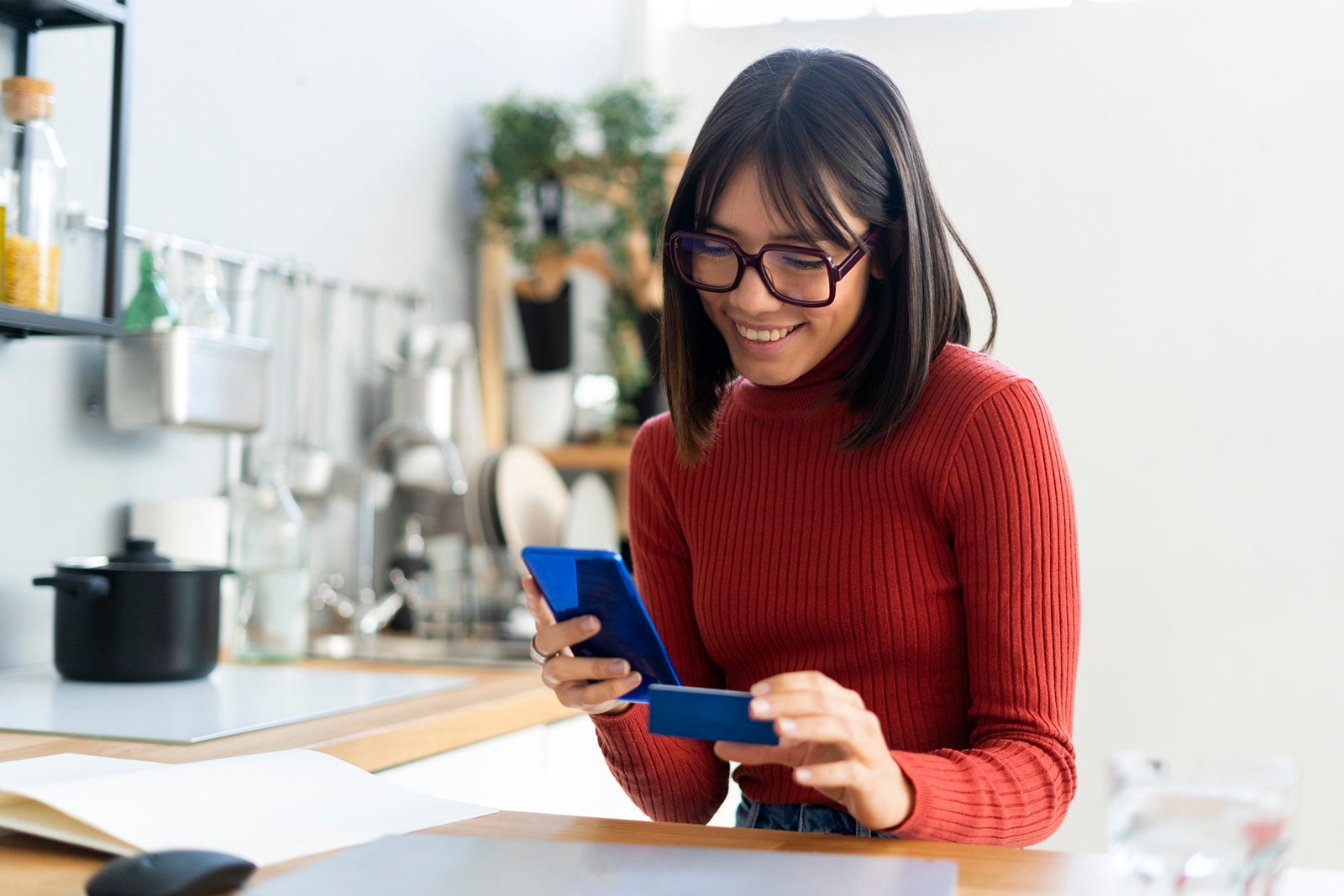 Smiling businesswoman doing online payment through credit card
