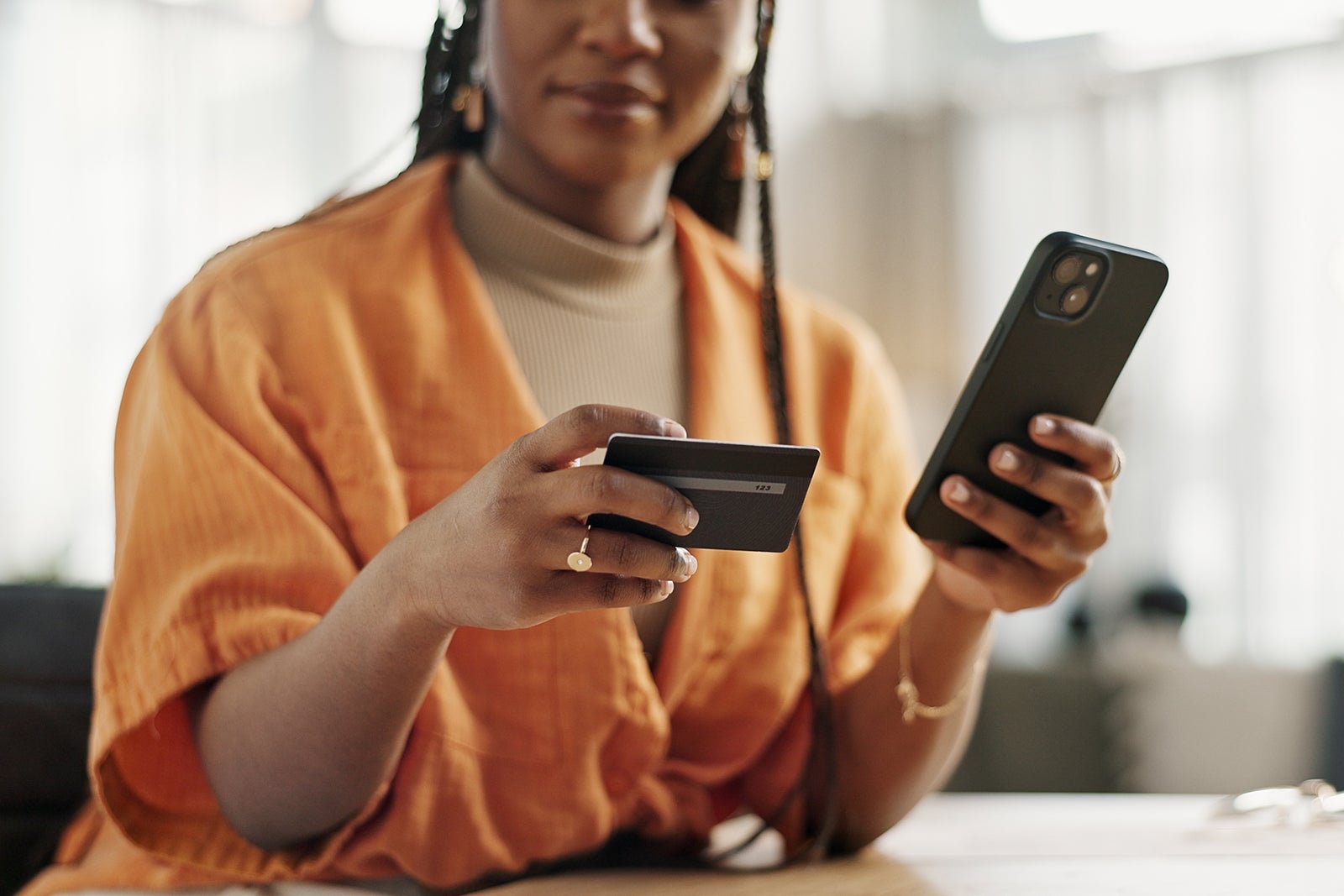 Woman, credit card and hands with phone for online shopping, payment or fintech savings at home. Closeup, mobile banking and finance for sales, password and code for ecommerce to upgrade subscription