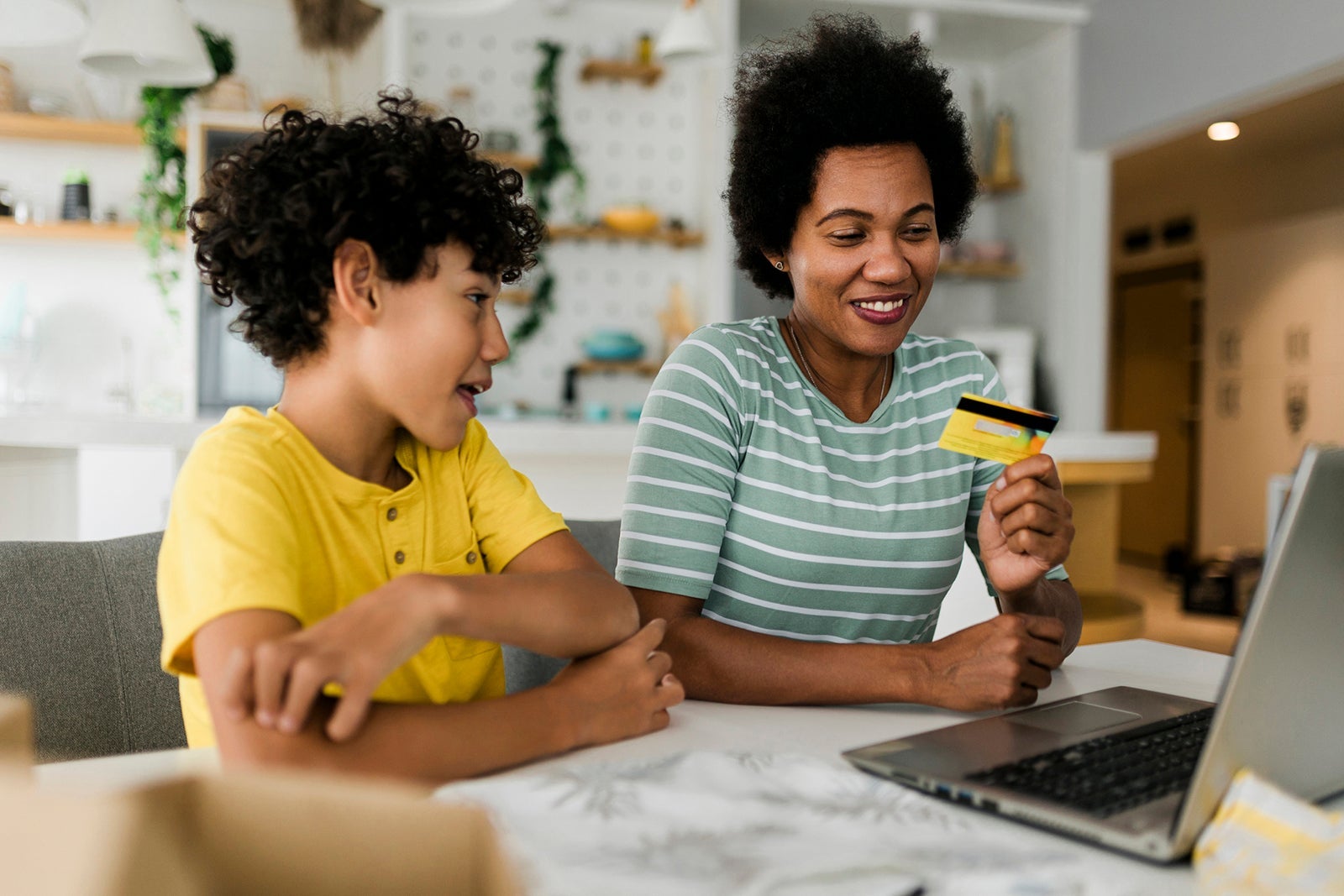 Mother and son online shopping at home