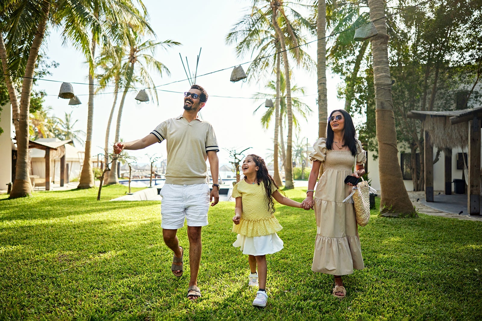 Happy family walking in resort garden