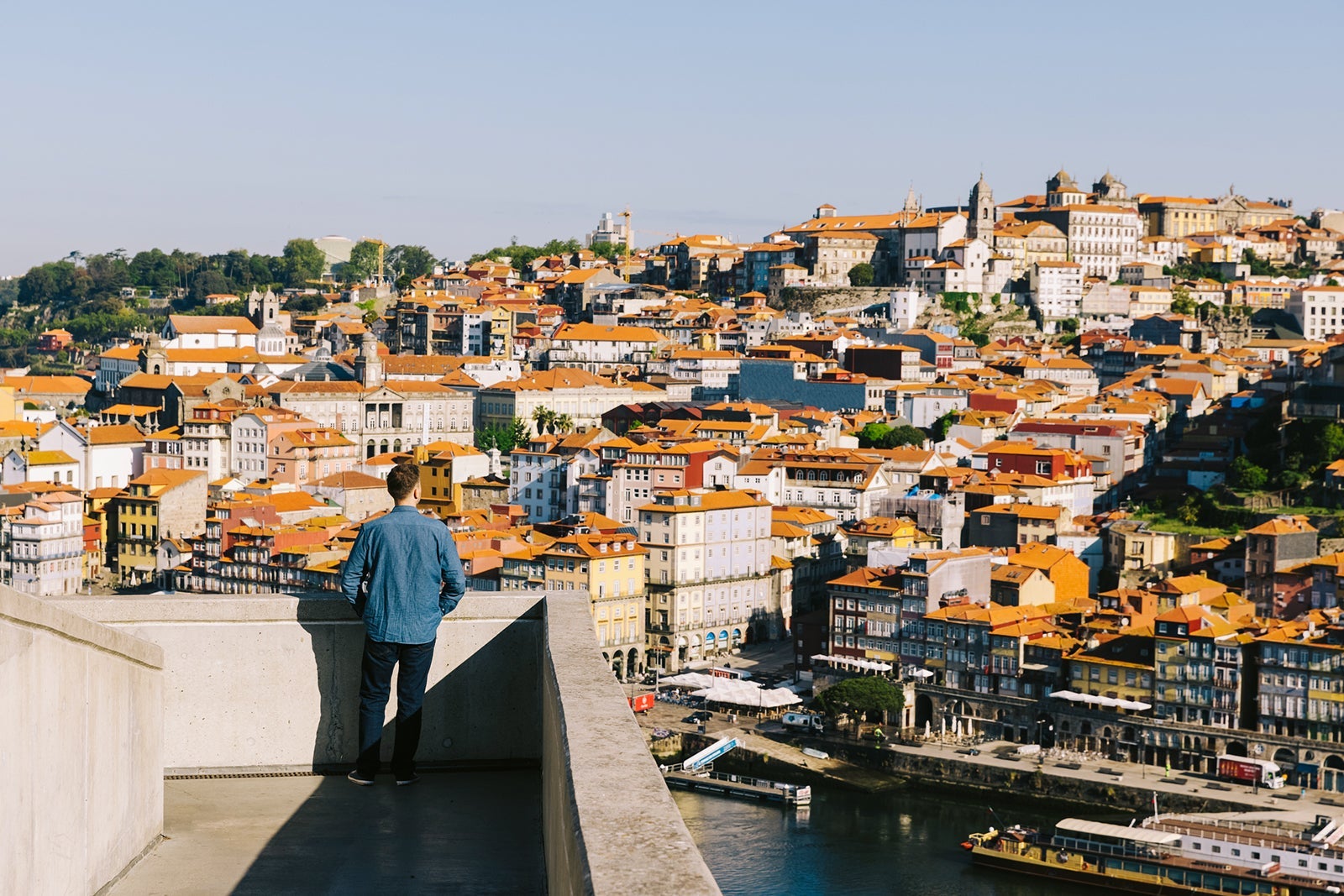 Rear view of a man looking at Porto cityscape from above