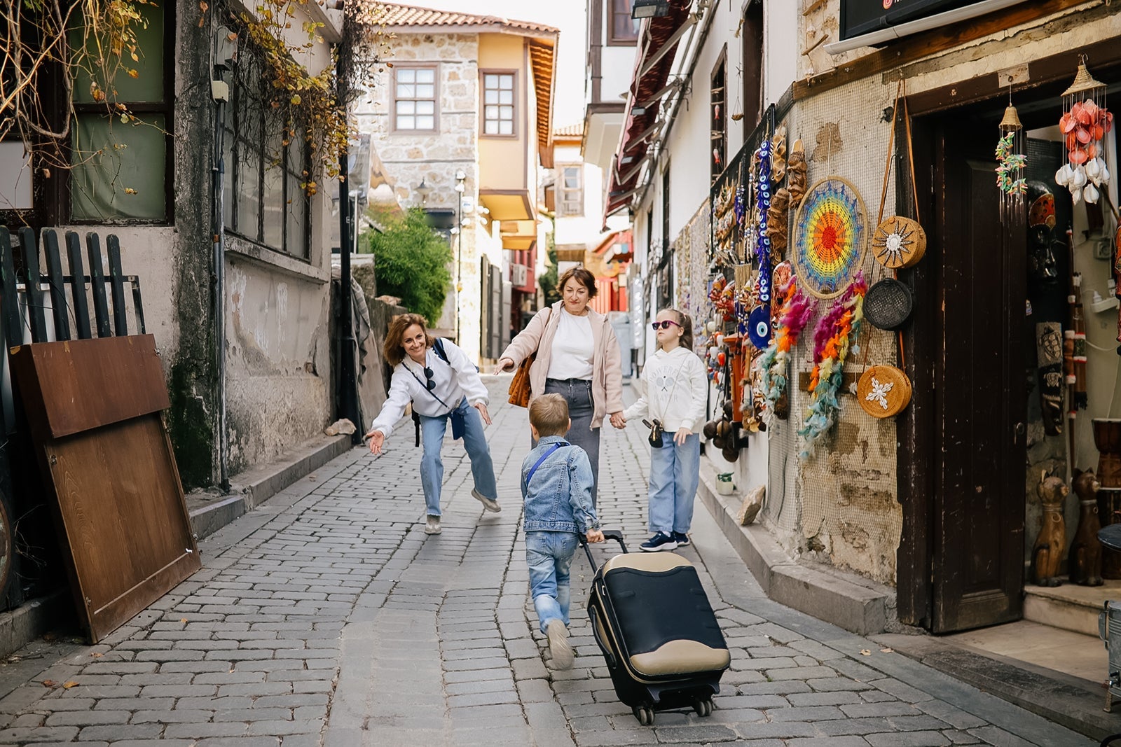 Market Excursion: Mom, Grandma, and Two Sibling Kids Enjoy a Leisurely Stroll Through Traditional Turkish Bazaar.