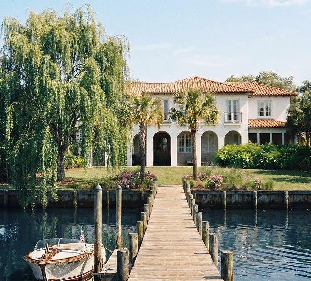 Waterfront house with a wooden dock and a boat